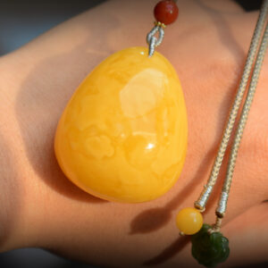 Discover elegance with our handcrafted natural amber teardrop pendant featuring South Red Agate and 18K gold. Perfect for any occasion, this exquisite piece blends timeless beauty with artisan craftsmanship.