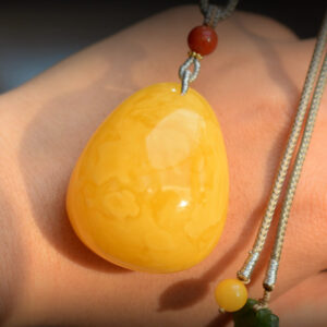 Discover elegance with our handcrafted natural amber teardrop pendant featuring South Red Agate and 18K gold. Perfect for any occasion, this exquisite piece blends timeless beauty with artisan craftsmanship.